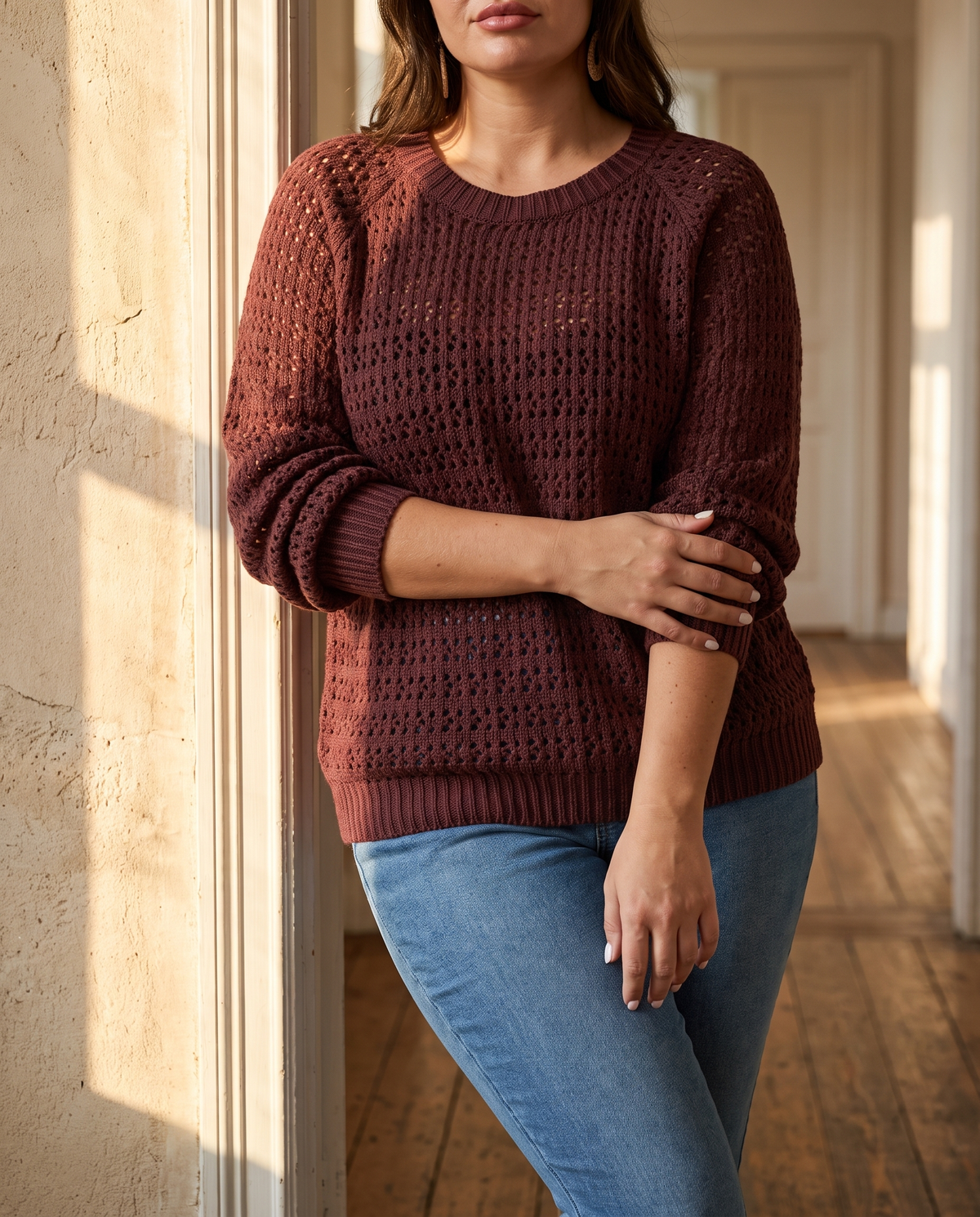 Plus size cable knit sweater for women in plum with cut out detail, sunlit doorway