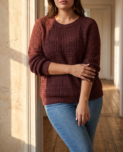 Plus size cable knit sweater for women in plum with cut out detail, sunlit doorway