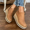Platform Chelsea boots for women slip on worn with jeans on a wet city street
