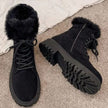 Lace up boots for women with faux fur collar and lug sole on a snowy sidewalk
