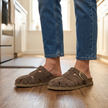 Clogs with strap for women, taupe suede buckle clogs worn with jeans on a kitchen floor