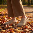 Suede clogs for women, loafer clog mules with cork sole on an autumn park path