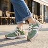 Retro chunky platform sneakers for women worn with cuffed jeans on a sunlit pavement