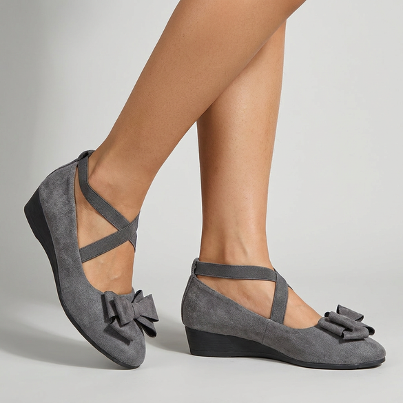Women's comfortable ballet flats in neutral shades on a studio floor