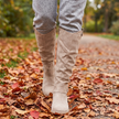 Cushioned comfort ankle boots for women walking on a leaf covered park path