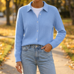 Women's collared button up cardigan sweater worn on an autumn sidewalk
