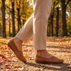 Women's arch support shoes, brown slip-on walking shoes on an autumn path