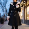 Women's long winter coat with faux fur trim hood in black, worn closed