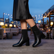 Knit sock boots for women in black with pointed toe block heel, lifestyle