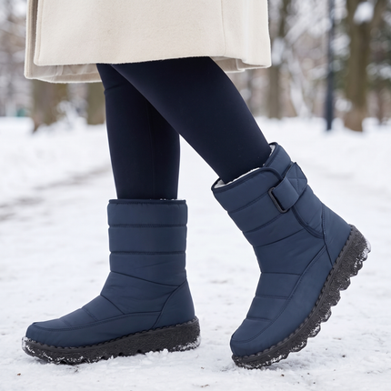 navy waterproof snow boots for women on a snowy park path