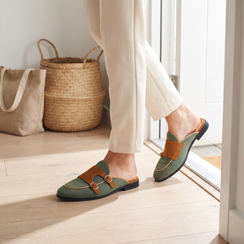 Suede slippers for women in green with gold buckle in an entryway
