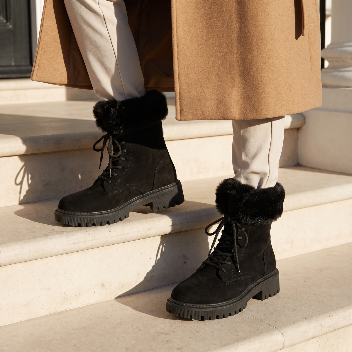 Lace up boots for women in black on townhouse steps