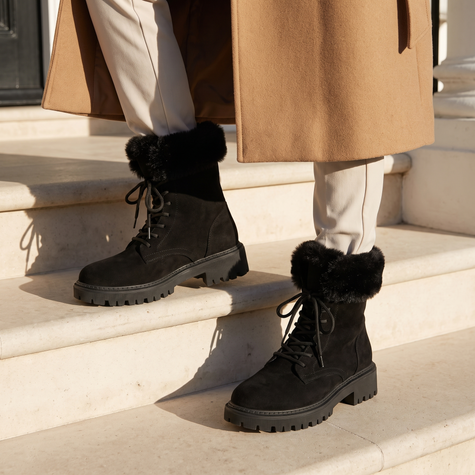 Lace up boots for women in black on townhouse steps