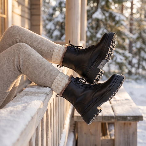 Ankle snow boots for women on a cabin porch