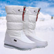 White snow boots for women quilted lace up boots on a snowy path